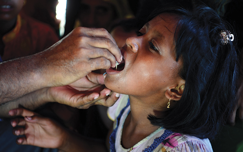 Child taking oral cholera vaccine